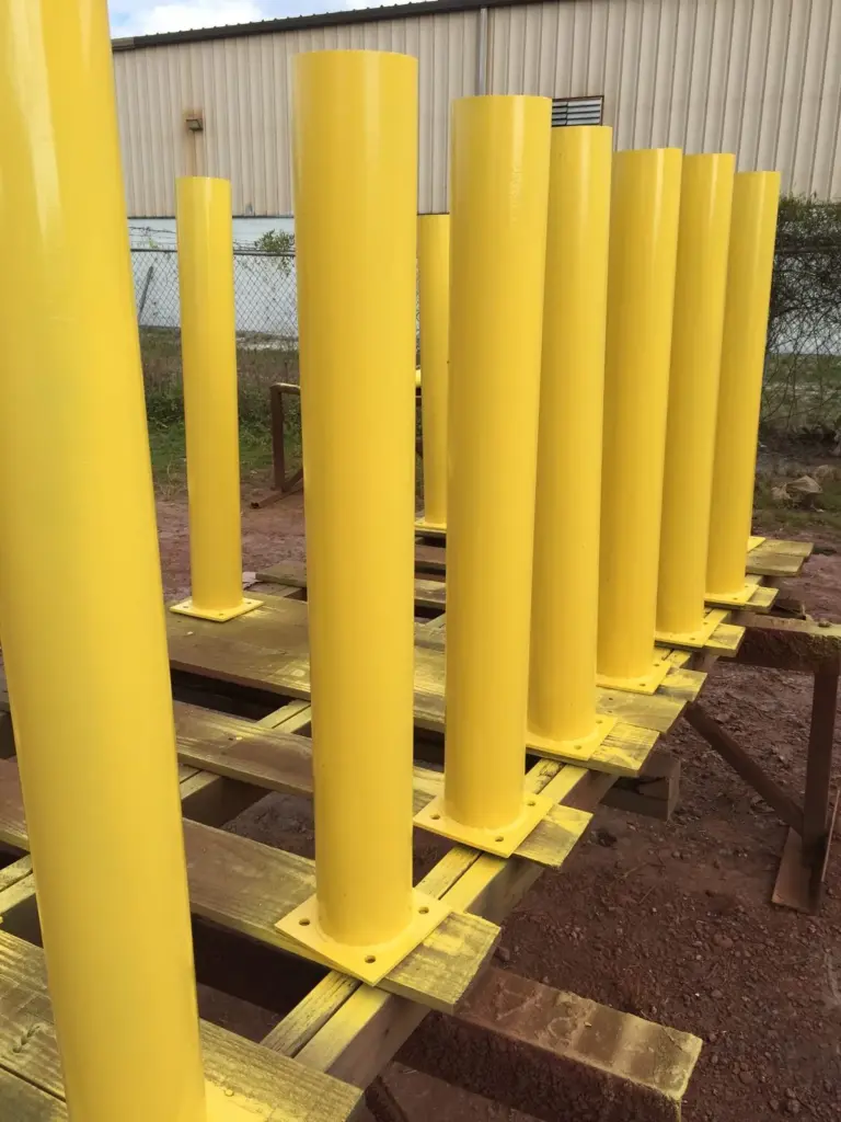 Steel Pipe Bollards 5 Powder-coated yellow steel pipe bollards during fabrication